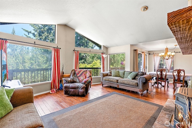 21410 SE 265th Pl, Maple Valley, WA 98038 - living room featuring a chandelier, hardwood / wood-style flooring, and vaulted ceiling