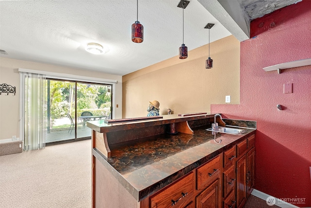 21410 SE 265th Pl, Maple Valley, WA 98038 - kitchen with a textured wall, a peninsula, pendant lighting, light colored carpet, and a textured ceiling