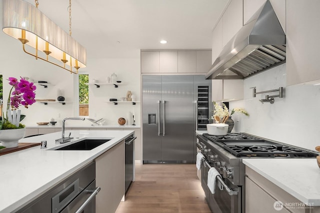 3968 162nd Pl SE, Bellevue, WA 98006 - kitchen featuring ventilation hood, high end appliances, recessed lighting, light countertops, and light wood-type flooring