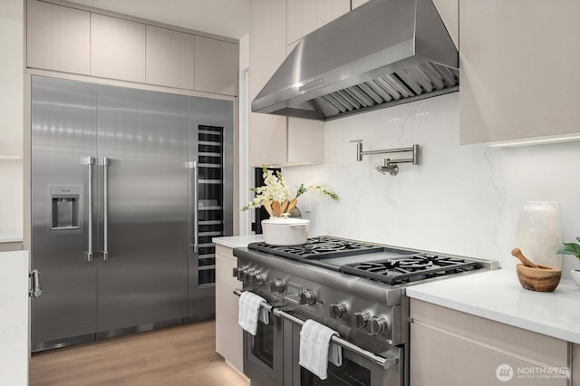 3968 162nd Pl SE, Bellevue, WA 98006 - kitchen with extractor fan, high quality appliances, light wood finished floors, light countertops, and modern cabinets