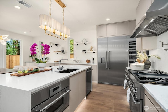 3968 162nd Pl SE, Bellevue, WA 98006 - kitchen featuring wall chimney exhaust hood, appliances with stainless steel finishes, light wood-style flooring, light countertops, and recessed lighting