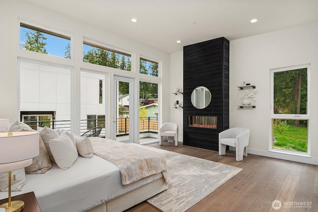 3968 162nd Pl SE, Bellevue, WA 98006 - bedroom with a large fireplace, wood-type flooring, recessed lighting, and access to exterior