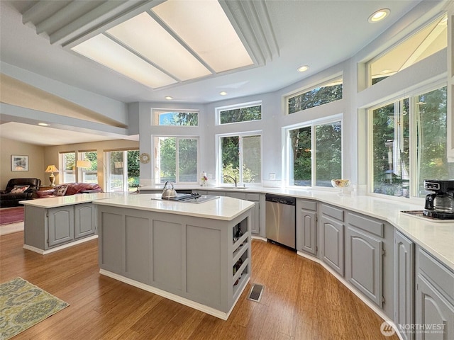 77 A Rd, Less Traveled, Sequim, WA 98382 - kitchen featuring stainless steel dishwasher, gray cabinetry, healthy amount of natural light, light countertops, and recessed lighting