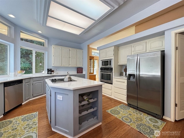 77 A Rd, Less Traveled, Sequim, WA 98382 - kitchen featuring stainless steel appliances, a kitchen island, light countertops, gray cabinetry, and dark wood-type flooring