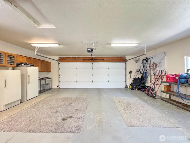 77 A Rd, Less Traveled, Sequim, WA 98382 - garage with freestanding refrigerator and a garage door opener