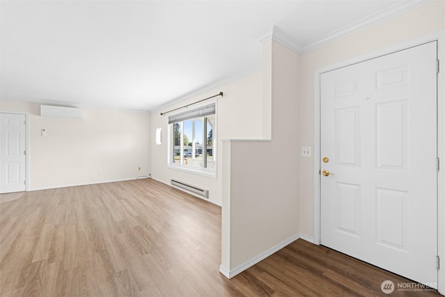 2512 Columbus Ave, Port Angeles, WA 98362 - entryway featuring a wall mounted air conditioner, a baseboard heating unit, wood finished floors, and crown molding