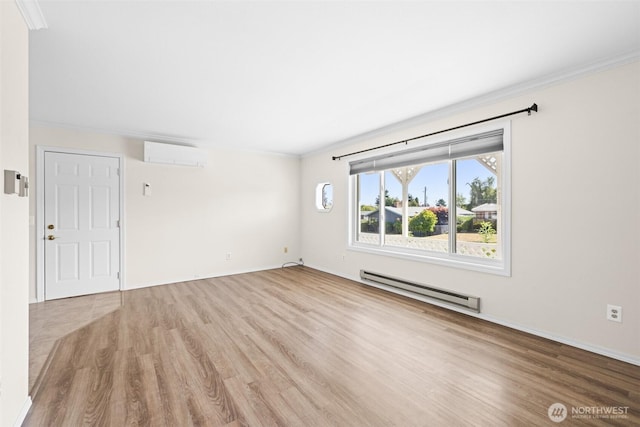 2512 Columbus Ave, Port Angeles, WA 98362 - spare room with baseboard heating, a wall mounted air conditioner, wood finished floors, and ornamental molding