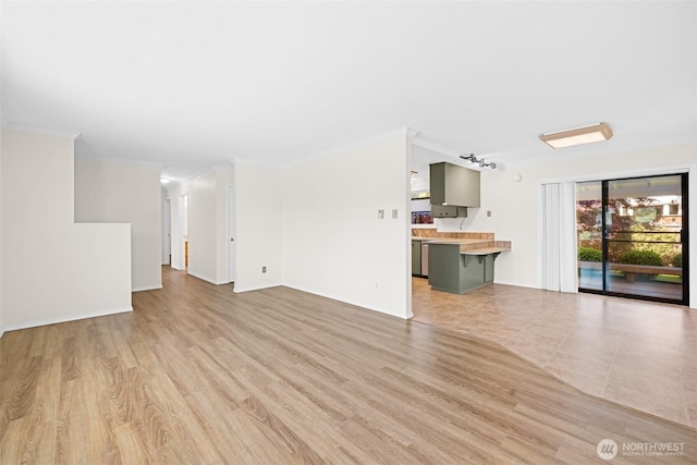 2512 Columbus Ave, Port Angeles, WA 98362 - unfurnished living room featuring crown molding and light wood-style flooring