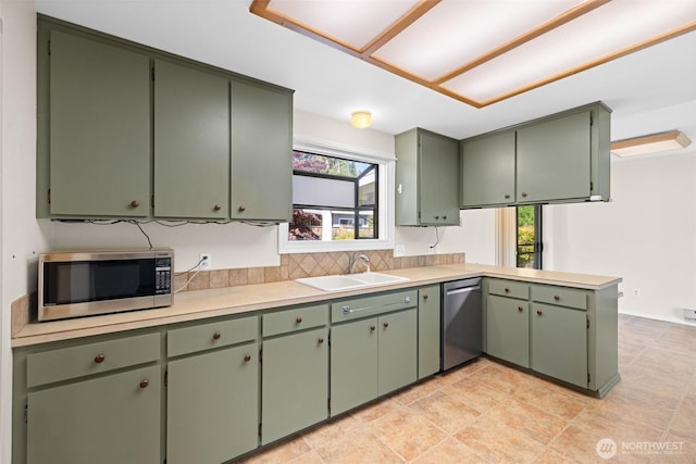 2512 Columbus Ave, Port Angeles, WA 98362 - kitchen featuring appliances with stainless steel finishes, plenty of natural light, light countertops, and green cabinets