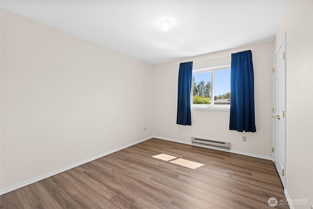 2512 Columbus Ave, Port Angeles, WA 98362 - spare room featuring a baseboard radiator and wood finished floors