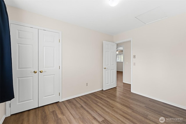 2512 Columbus Ave, Port Angeles, WA 98362 - unfurnished bedroom featuring wood finished floors, attic access, and a closet