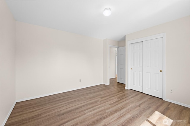 2512 Columbus Ave, Port Angeles, WA 98362 - unfurnished bedroom featuring wood finished floors and a closet