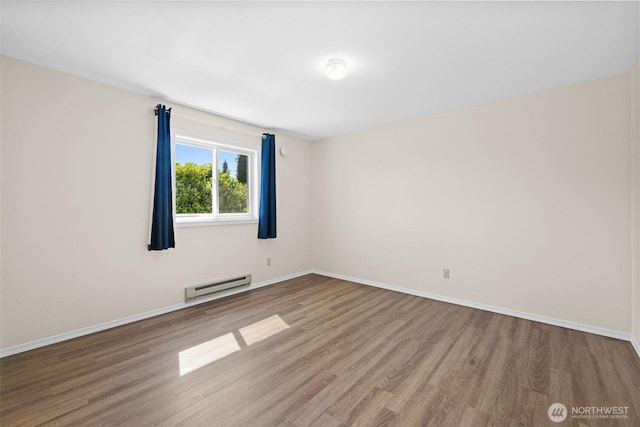 2512 Columbus Ave, Port Angeles, WA 98362 - empty room with a baseboard radiator and wood finished floors