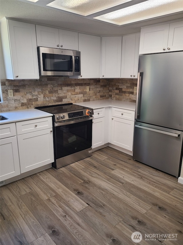 118 17th Ave SE, Olympia, WA 98501 - kitchen featuring appliances with stainless steel finishes, light countertops, and tasteful backsplash