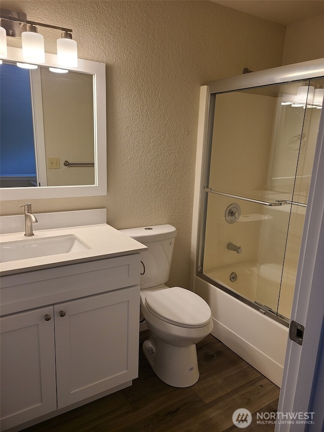 118 17th Ave SE, Olympia, WA 98501 - bathroom with a textured wall, wood finished floors, vanity, and enclosed tub / shower combo