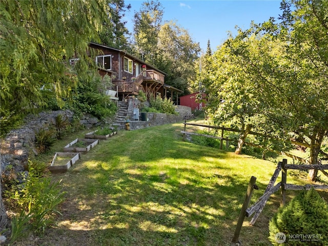 14068 Crater Lake Rd, Anacortes, WA 98221 - view of green lawn with a vegetable garden, stairs, and a deck