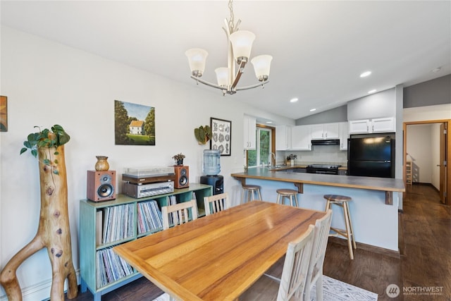 14068 Crater Lake Rd, Anacortes, WA 98221 - dining area with a chandelier, vaulted ceiling, dark wood-style flooring, and recessed lighting