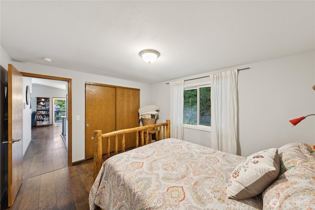 14068 Crater Lake Rd, Anacortes, WA 98221 - bedroom featuring multiple windows, dark wood-style flooring, and a closet