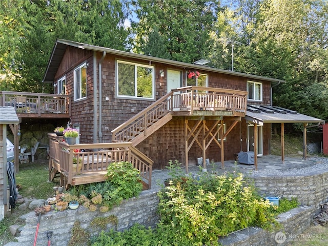 14068 Crater Lake Rd, Anacortes, WA 98221 - view of front of house featuring a wooden deck, stairs, and a patio