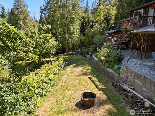 14068 Crater Lake Rd, Anacortes, WA 98221 - view of grassy yard with a fire pit, a deck, and stairs