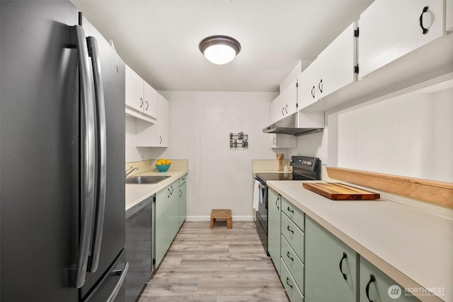 303 Kenyon St NW Unit 2D, Olympia, WA 98502 - kitchen with freestanding refrigerator, black / electric stove, green cabinets, under cabinet range hood, and light countertops