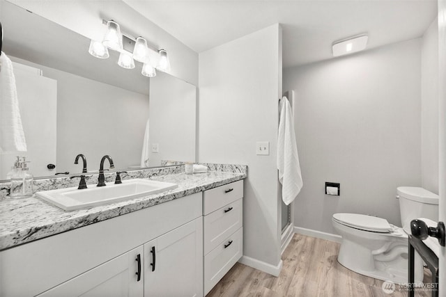 303 Kenyon St NW Unit 2D, Olympia, WA 98502 - full bathroom featuring vanity, wood finished floors, and a shower with door
