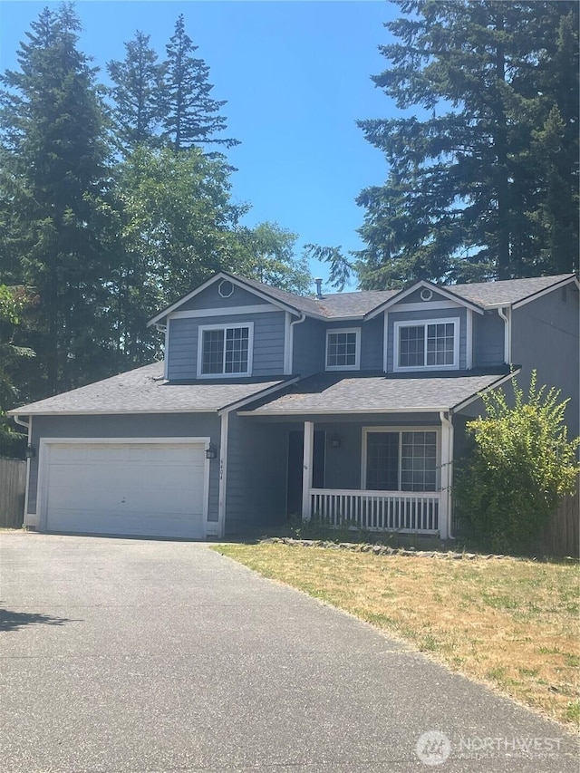 6404 220th Street Ct E, Spanaway, WA 98387 - traditional-style home with a porch, asphalt driveway, a shingled roof, and an attached garage