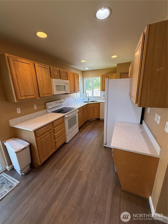 6404 220th Street Ct E, Spanaway, WA 98387 - kitchen with white appliances, dark wood-type flooring, light countertops, brown cabinets, and recessed lighting
