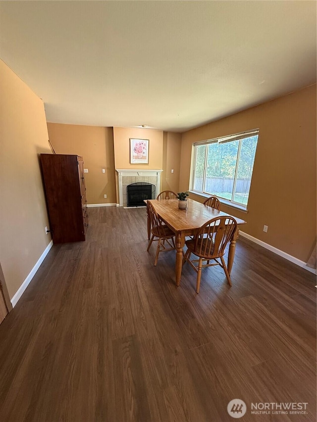 6404 220th Street Ct E, Spanaway, WA 98387 - dining space with dark wood-style flooring and a tiled fireplace
