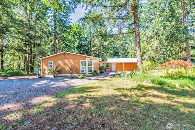 8310 207th St E, Spanaway, WA 98387 - back of house with a lawn and a forest view