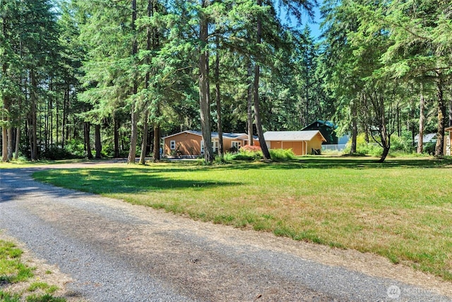 8310 207th St E, Spanaway, WA 98387 - view of front of house featuring driveway and a front yard