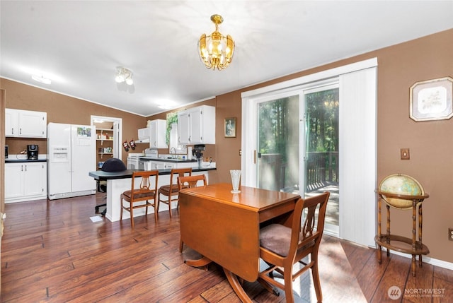 8310 207th St E, Spanaway, WA 98387 - dining room with dark wood-style floors and a chandelier