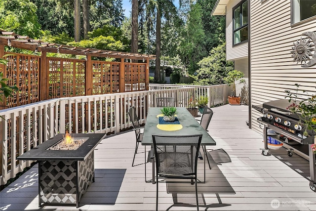 16671 SE 17th Pl, Bellevue, WA 98008 - wooden deck featuring a fire pit, outdoor dining area, view of wooded area, and grilling area