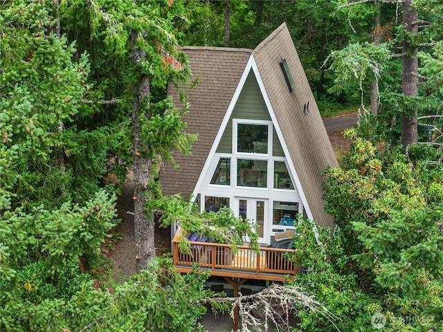 22305 Autumnwood Ct SE, Yelm, WA 98597 - rear view of property featuring a shingled roof and a wooden deck
