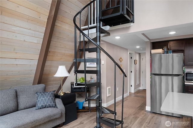 22305 Autumnwood Ct SE, Yelm, WA 98597 - staircase with wooden walls, wood finished floors, and recessed lighting