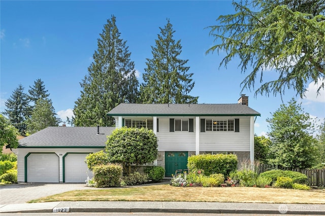 1023 144th Pl SE, Bellevue, WA 98007 - view of front of property with a chimney, an attached garage, driveway, and brick siding