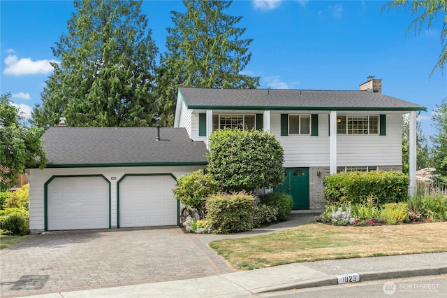 1023 144th Pl SE, Bellevue, WA 98007 - view of front of property with an attached garage, a chimney, decorative driveway, a front lawn, and brick siding