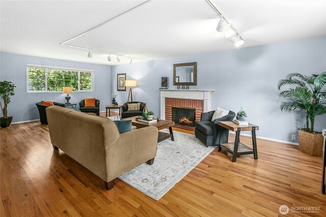1023 144th Pl SE, Bellevue, WA 98007 - living area with track lighting, a fireplace, and wood finished floors