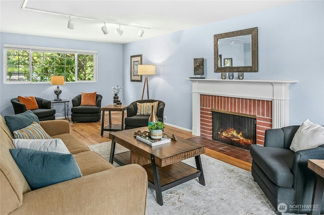 1023 144th Pl SE, Bellevue, WA 98007 - living area featuring wood finished floors, a brick fireplace, and rail lighting
