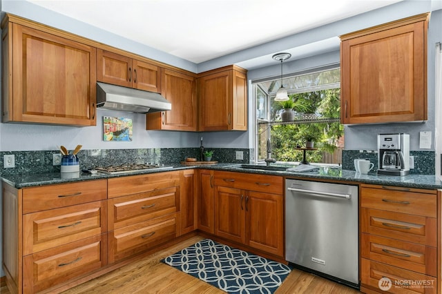 1023 144th Pl SE, Bellevue, WA 98007 - kitchen featuring appliances with stainless steel finishes, under cabinet range hood, brown cabinetry, and dark stone counters