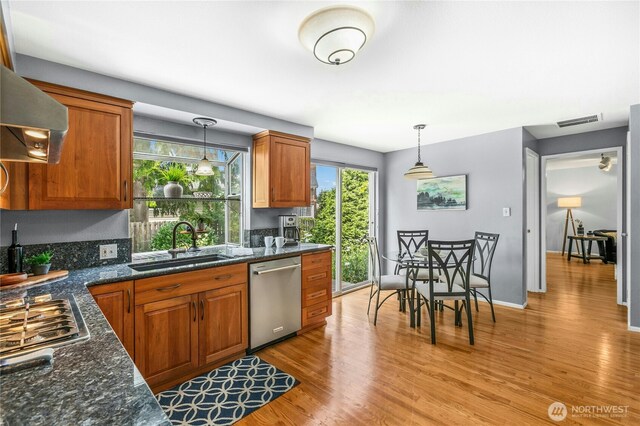 1023 144th Pl SE, Bellevue, WA 98007 - kitchen featuring stainless steel appliances, ventilation hood, light wood finished floors, and brown cabinets