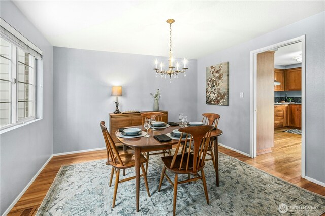 1023 144th Pl SE, Bellevue, WA 98007 - dining space featuring a chandelier and light wood-style flooring