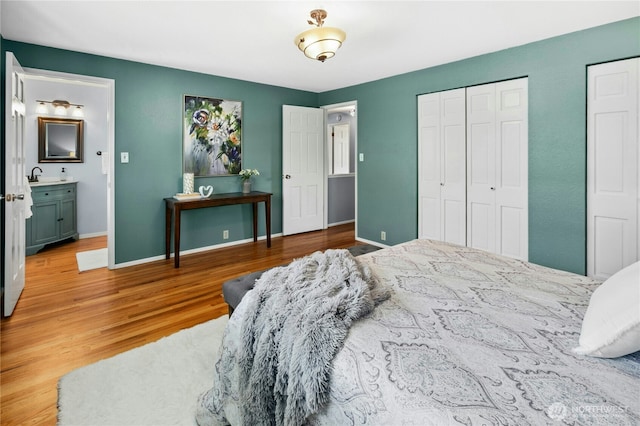 1023 144th Pl SE, Bellevue, WA 98007 - bedroom featuring wood finished floors and multiple closets