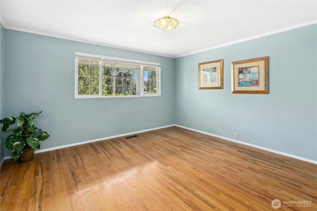 1023 144th Pl SE, Bellevue, WA 98007 - empty room featuring crown molding and wood finished floors