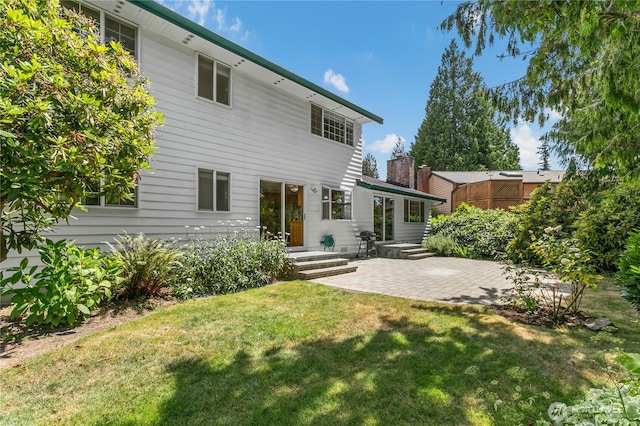 1023 144th Pl SE, Bellevue, WA 98007 - rear view of house featuring a patio and a lawn