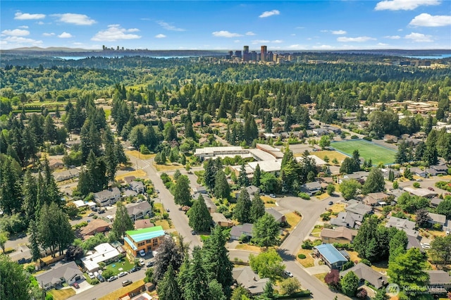1023 144th Pl SE, Bellevue, WA 98007 - aerial view of property and surrounding area featuring a heavily wooded area and nearby suburban area