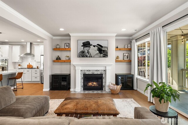 28621 NE 156th St, Duvall, WA 98019 - living area featuring light wood-type flooring, a fireplace, recessed lighting, and ornamental molding