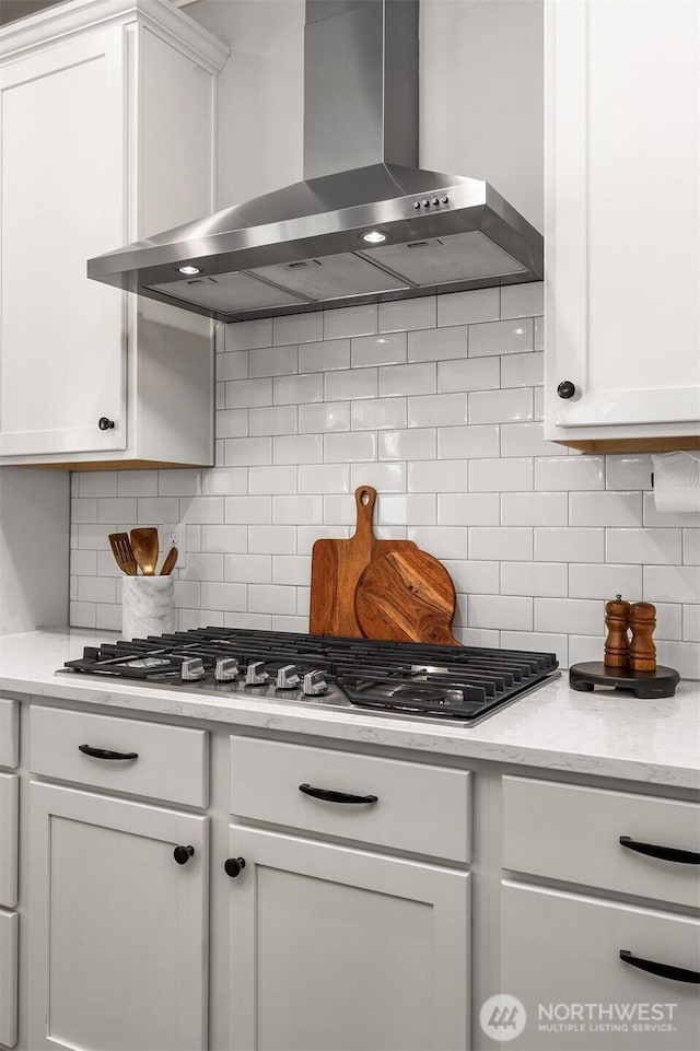 28621 NE 156th St, Duvall, WA 98019 - kitchen with wall chimney range hood, white cabinetry, tasteful backsplash, and stainless steel gas cooktop