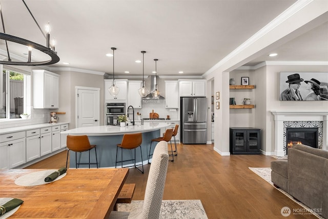 28621 NE 156th St, Duvall, WA 98019 - kitchen with appliances with stainless steel finishes, wall chimney range hood, tasteful backsplash, ornamental molding, and white cabinets