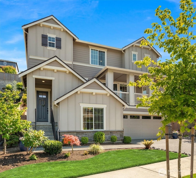 28621 NE 156th St, Duvall, WA 98019 - craftsman-style home with board and batten siding, a garage, a balcony, concrete driveway, and stone siding
